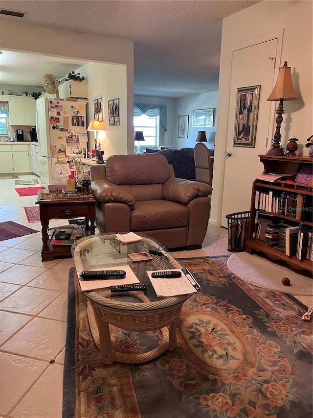 8552 SW 92nd Ln Unit C, Ocala, FL 34481 - living area featuring a textured ceiling and light tile patterned floors