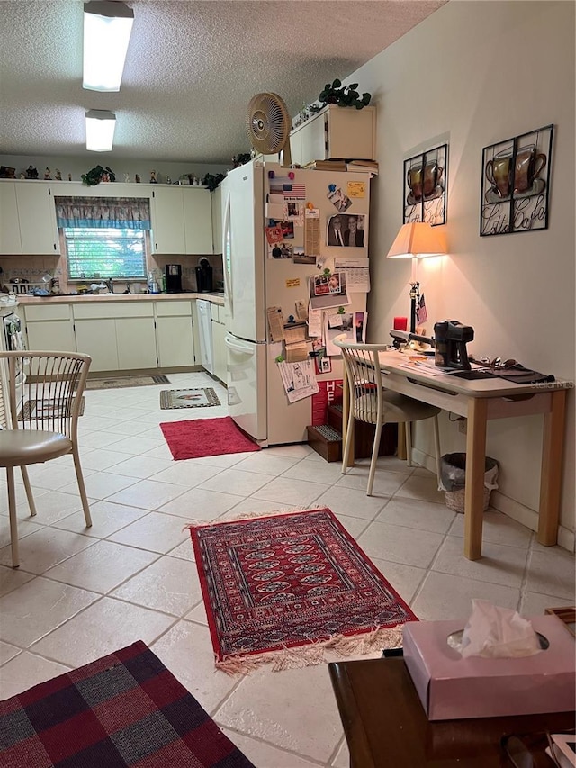 8552 SW 92nd Ln Unit C, Ocala, FL 34481 - kitchen featuring freestanding refrigerator, a textured ceiling, light countertops, an office area, and light tile patterned floors