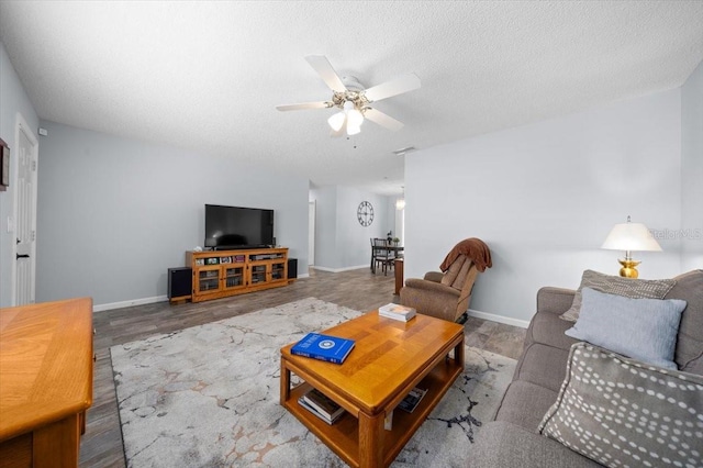 10492 SE 178th St, Summerfield, FL 34491 - living area with ceiling fan, wood finished floors, and a textured ceiling