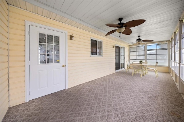 10492 SE 178th St, Summerfield, FL 34491 - unfurnished sunroom with carpet floors, a ceiling fan, wood walls, and wooden ceiling