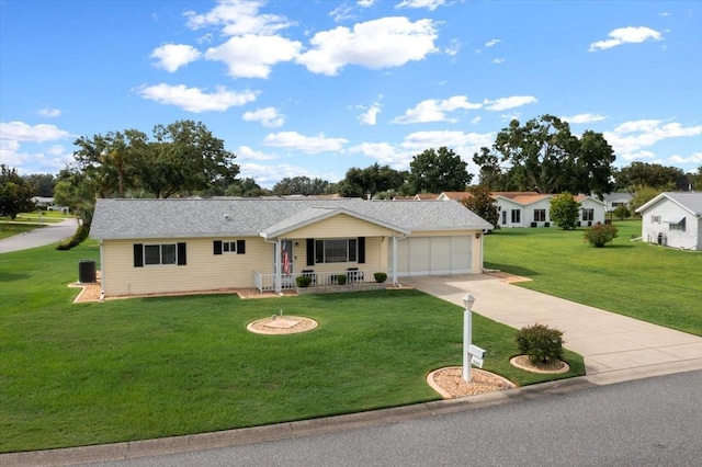 10492 SE 178th St, Summerfield, FL 34491 - ranch-style home featuring a porch, concrete driveway, a garage, and a front yard