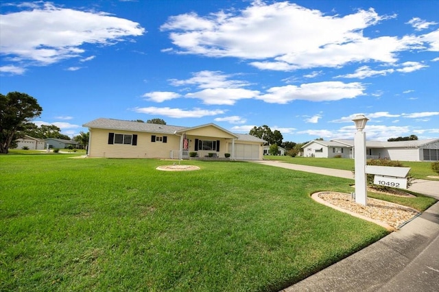 10492 SE 178th St, Summerfield, FL 34491 - ranch-style home featuring concrete driveway, a front lawn, and an attached garage