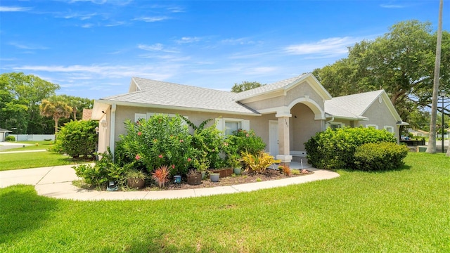 705 Guava Dr, Saint Augustine, FL 32095 - view of front facade featuring a front yard, stucco siding, roof with shingles, and concrete driveway