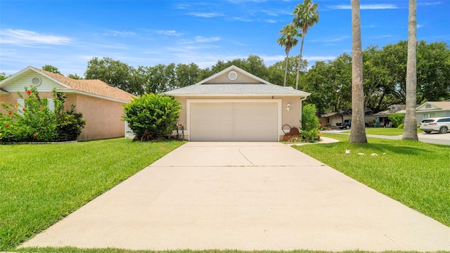 705 Guava Dr, Saint Augustine, FL 32095 - view of front of home featuring a front yard, driveway, stucco siding, and an attached garage