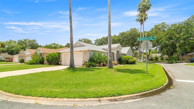 705 Guava Dr, Saint Augustine, FL 32095 - view of front facade with a front yard, a garage, driveway, and stucco siding