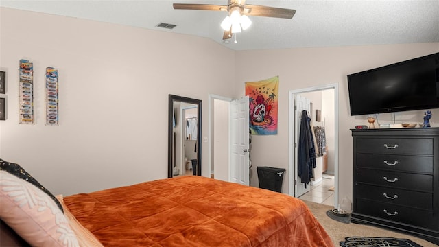 705 Guava Dr, Saint Augustine, FL 32095 - bedroom featuring lofted ceiling, light tile patterned flooring, a ceiling fan, and connected bathroom