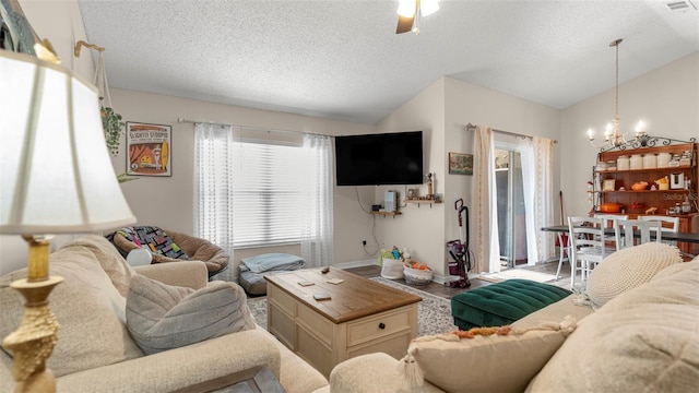 705 Guava Dr, Saint Augustine, FL 32095 - living area featuring lofted ceiling, a chandelier, and a textured ceiling