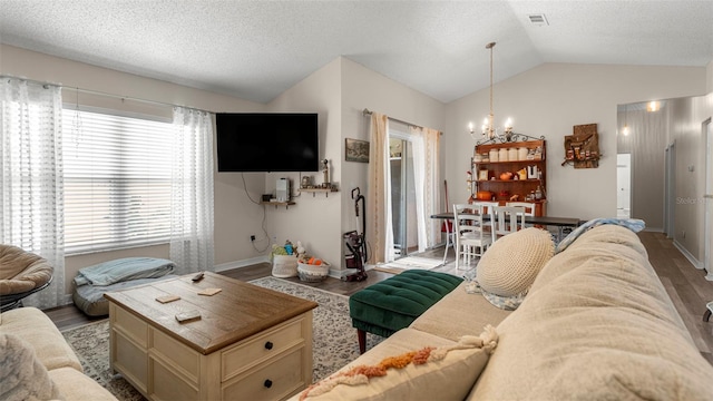 705 Guava Dr, Saint Augustine, FL 32095 - living room with a chandelier, wood finished floors, vaulted ceiling, and a textured ceiling