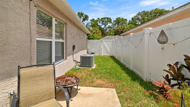 705 Guava Dr, Saint Augustine, FL 32095 - fenced backyard with a gate, a fire pit, and a patio area