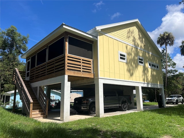 5328 Riverside Dr, Yankeetown, FL 34498 - back of property featuring a carport, a sunroom, and stairway