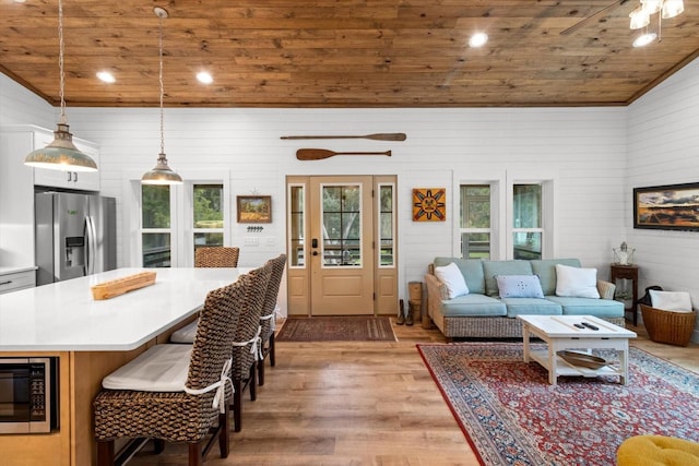 5328 Riverside Dr, Yankeetown, FL 34498 - living area with wood ceiling, light wood-style floors, vaulted ceiling, recessed lighting, and wood walls