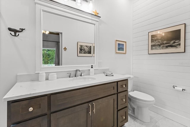 5328 Riverside Dr, Yankeetown, FL 34498 - bathroom featuring wood walls, vanity, and marble finish flooring