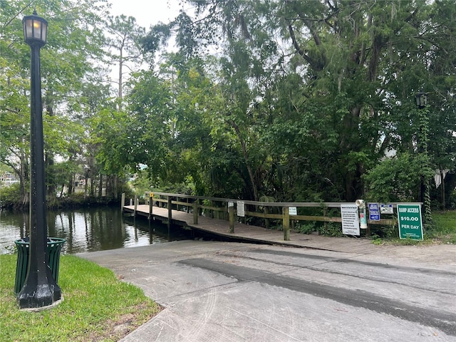 5328 Riverside Dr, Yankeetown, FL 34498 - dock area featuring a boat ramp, a water view, and view of scattered trees