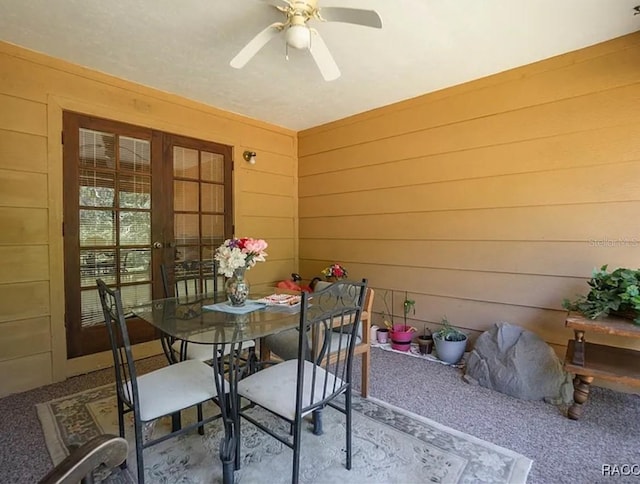210 E Glassboro Ct Unit 6A, Hernando, FL 34442 - dining space featuring carpet, wooden walls, ceiling fan, and french doors