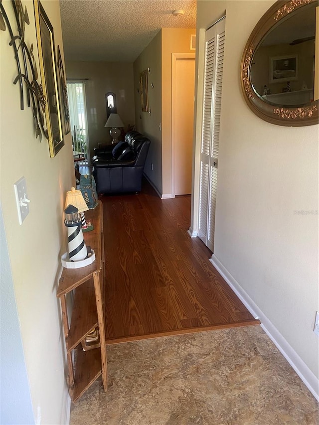 9771 SW 97th Ln, Ocala, FL 34481 - corridor with a textured ceiling and baseboards