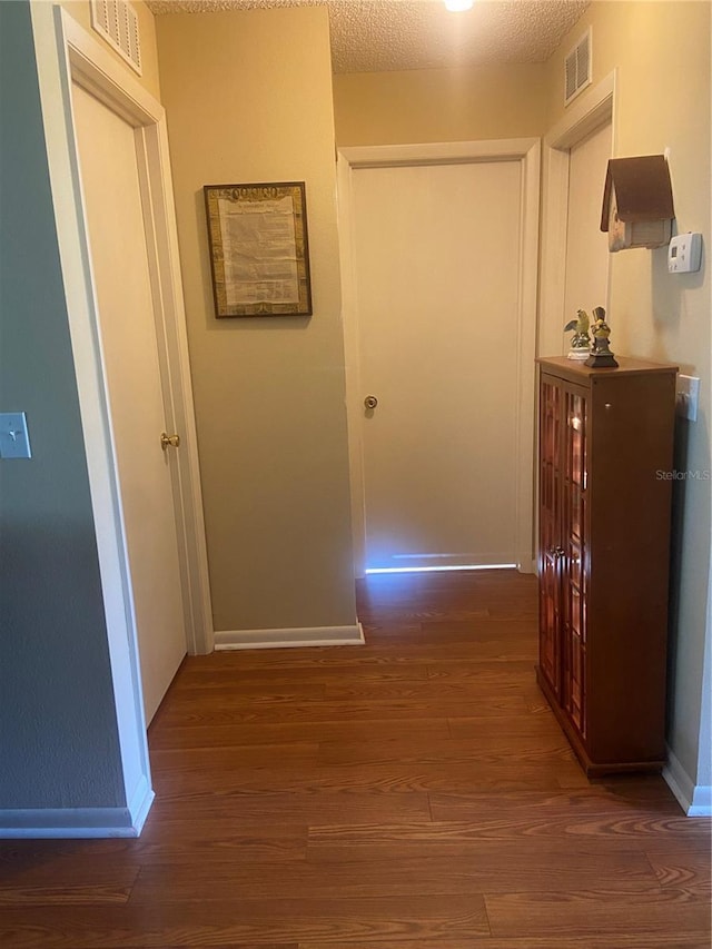 9771 SW 97th Ln, Ocala, FL 34481 - hall with wood finished floors and a textured ceiling