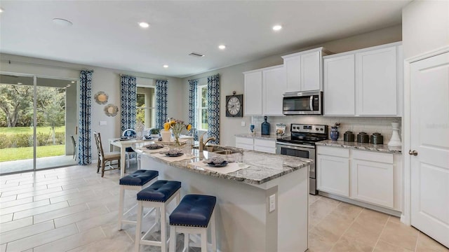 4253 SW 54th Street Rd, Ocala, FL 34474 - kitchen with stainless steel appliances, healthy amount of natural light, tasteful backsplash, white cabinets, and recessed lighting