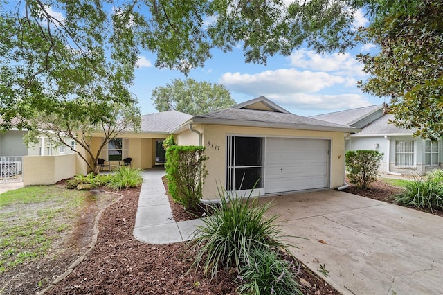9117 SW 93rd Cir, Ocala, FL 34481 - view of front of property featuring a garage, stucco siding, and concrete driveway