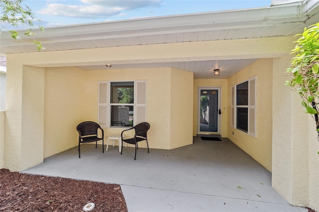 9117 SW 93rd Cir, Ocala, FL 34481 - view of exterior entry featuring a patio and stucco siding