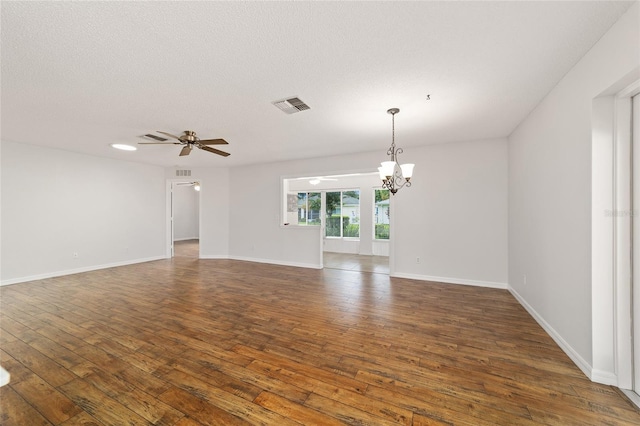 9117 SW 93rd Cir, Ocala, FL 34481 - unfurnished living room featuring a chandelier, dark wood-style floors, ceiling fan, and a textured ceiling