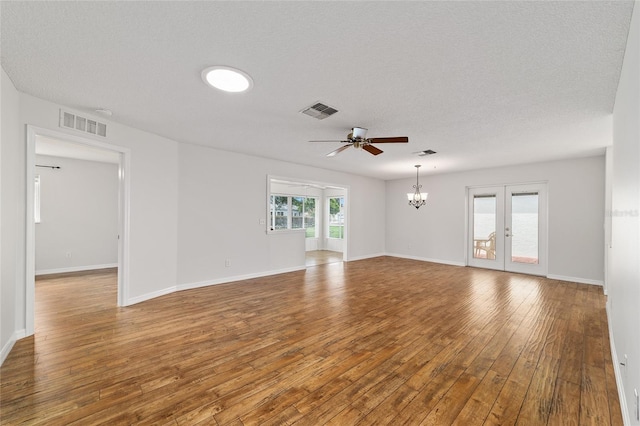 9117 SW 93rd Cir, Ocala, FL 34481 - spare room featuring a chandelier, a ceiling fan, wood-type flooring, and a textured ceiling