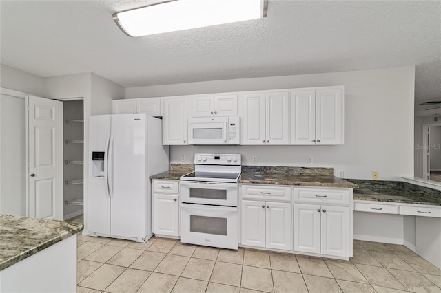 9117 SW 93rd Cir, Ocala, FL 34481 - kitchen with white appliances, white cabinetry, light tile patterned flooring, dark stone countertops, and a textured ceiling