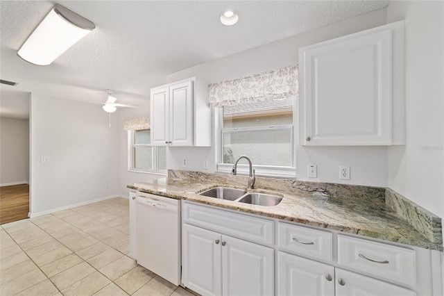 9117 SW 93rd Cir, Ocala, FL 34481 - kitchen with white dishwasher, white cabinetry, light stone countertops, and a textured ceiling