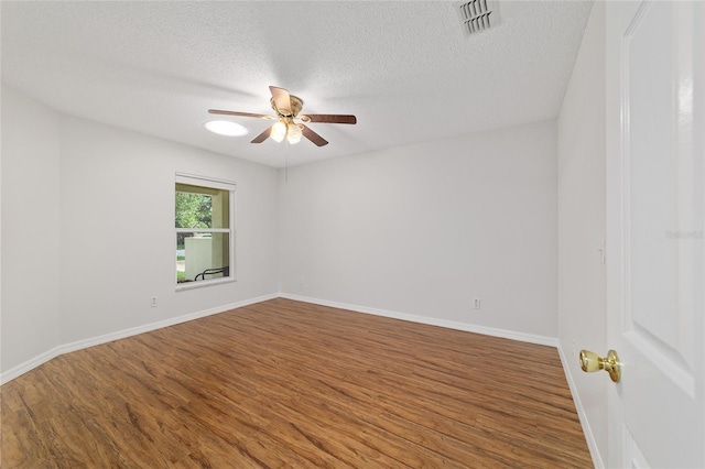 9117 SW 93rd Cir, Ocala, FL 34481 - unfurnished room with wood finished floors, a ceiling fan, and a textured ceiling