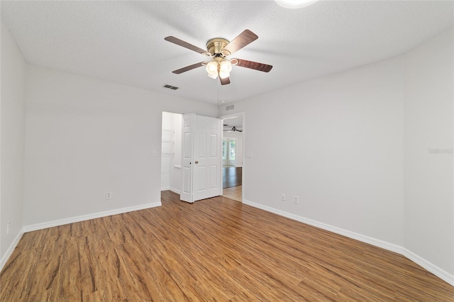 9117 SW 93rd Cir, Ocala, FL 34481 - unfurnished room with wood finished floors, a ceiling fan, and a textured ceiling