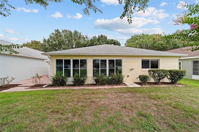 9117 SW 93rd Cir, Ocala, FL 34481 - rear view of property with stucco siding and a lawn