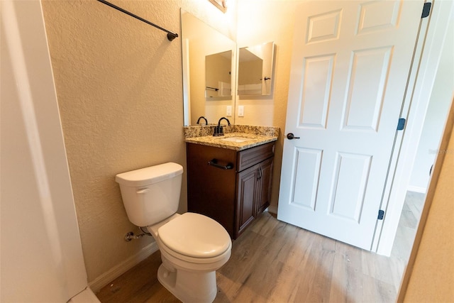 21 Locust Loop Radl, Ocala, FL 34472 - half bathroom featuring a textured wall, vanity, and wood finished floors