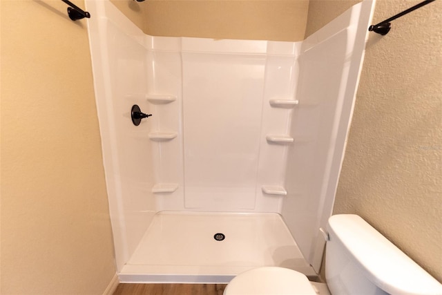 21 Locust Loop Radl, Ocala, FL 34472 - bathroom with a textured wall, a shower, and wood finished floors