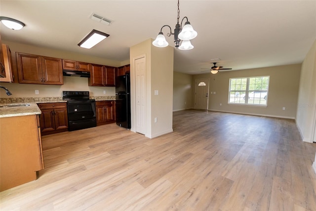 21 Locust Loop Radl, Ocala, FL 34472 - kitchen with black appliances, under cabinet range hood, a ceiling fan, light wood-type flooring, and open floor plan