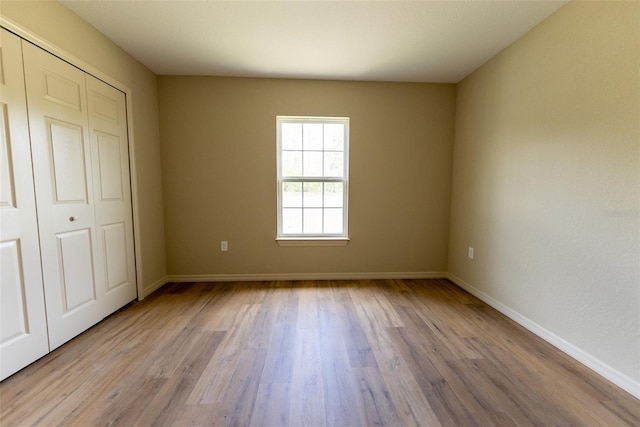 21 Locust Loop Radl, Ocala, FL 34472 - unfurnished bedroom with wood finished floors and a closet