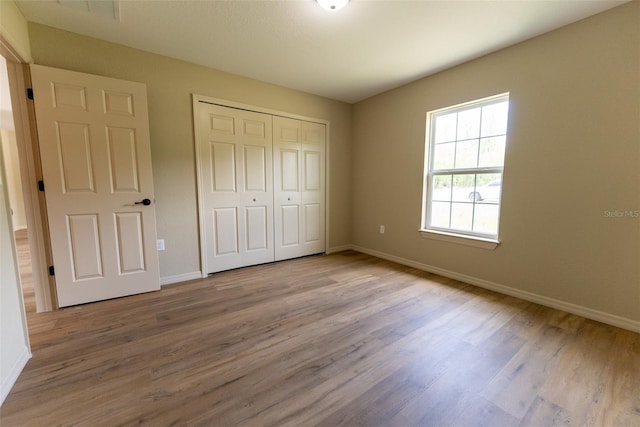 21 Locust Loop Radl, Ocala, FL 34472 - unfurnished bedroom with wood finished floors and a closet