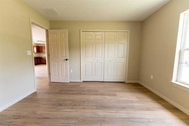 21 Locust Loop Radl, Ocala, FL 34472 - unfurnished bedroom with light wood-type flooring and a closet