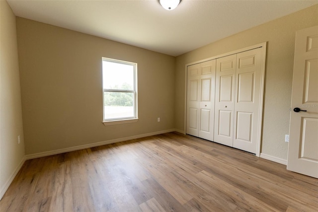 21 Locust Loop Radl, Ocala, FL 34472 - unfurnished bedroom with light wood-type flooring and a closet