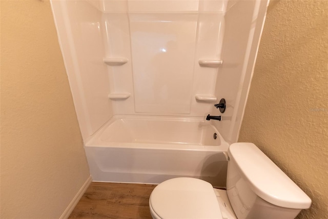 21 Locust Loop Radl, Ocala, FL 34472 - full bath featuring a textured wall, wood finished floors, and washtub / shower combination