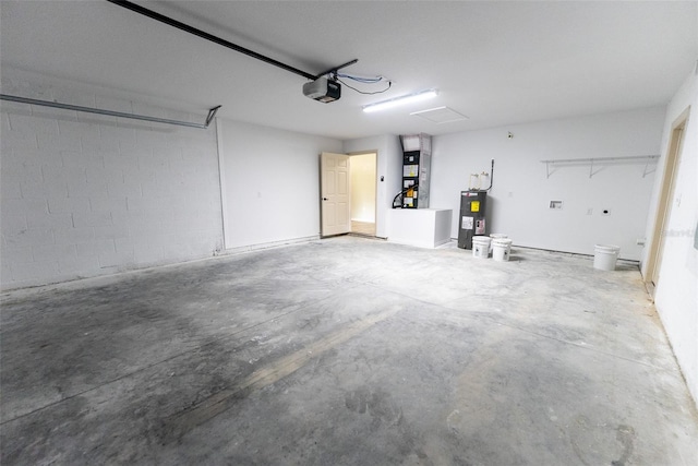21 Locust Loop Radl, Ocala, FL 34472 - garage with electric water heater, a garage door opener, heating unit, and concrete block wall