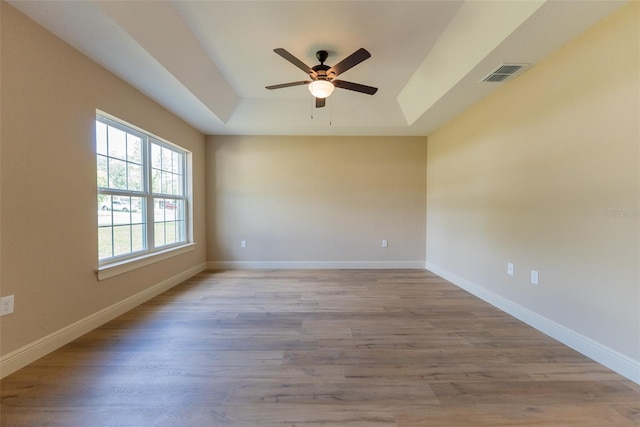 45 Pecan Course Loop, Ocala, FL 34472 - empty room with a raised ceiling, ceiling fan, and wood finished floors