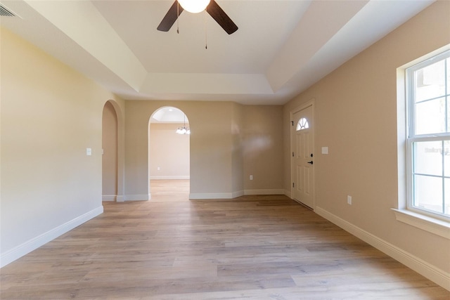 45 Pecan Course Loop, Ocala, FL 34472 - foyer entrance with a tray ceiling, light wood-type flooring, a ceiling fan, and arched walkways