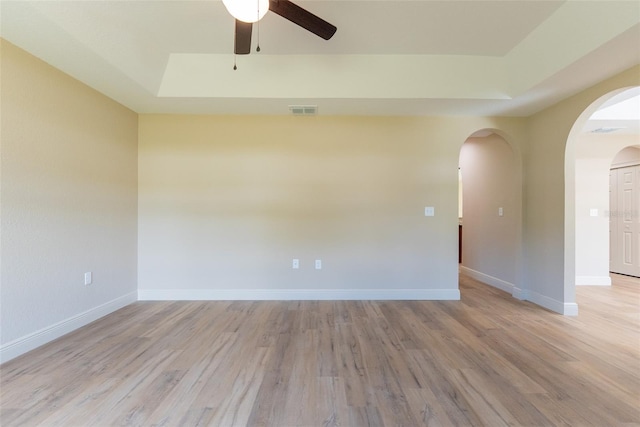 45 Pecan Course Loop, Ocala, FL 34472 - empty room featuring arched walkways, a ceiling fan, and light wood-style floors