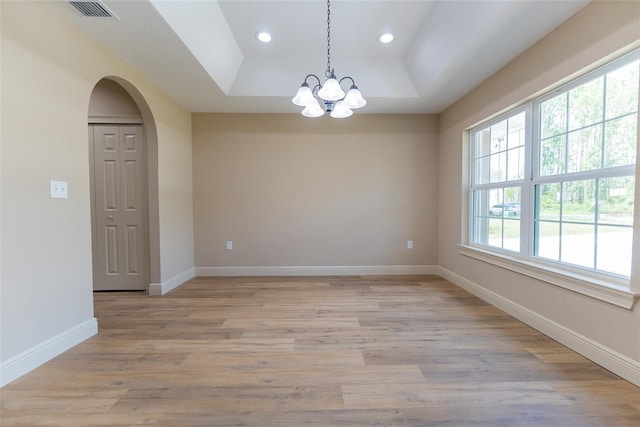 45 Pecan Course Loop, Ocala, FL 34472 - empty room featuring a tray ceiling, arched walkways, a chandelier, light wood-type flooring, and recessed lighting