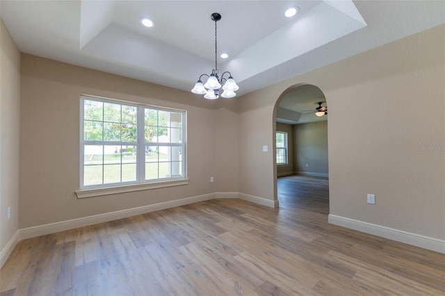 45 Pecan Course Loop, Ocala, FL 34472 - unfurnished room with a tray ceiling, arched walkways, light wood-style floors, recessed lighting, and a chandelier