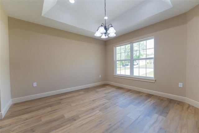 45 Pecan Course Loop, Ocala, FL 34472 - spare room featuring light wood-style flooring, a chandelier, a tray ceiling, and recessed lighting