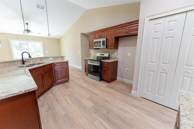 45 Pecan Course Loop, Ocala, FL 34472 - kitchen with appliances with stainless steel finishes, vaulted ceiling, ceiling fan, light wood-style flooring, and decorative light fixtures