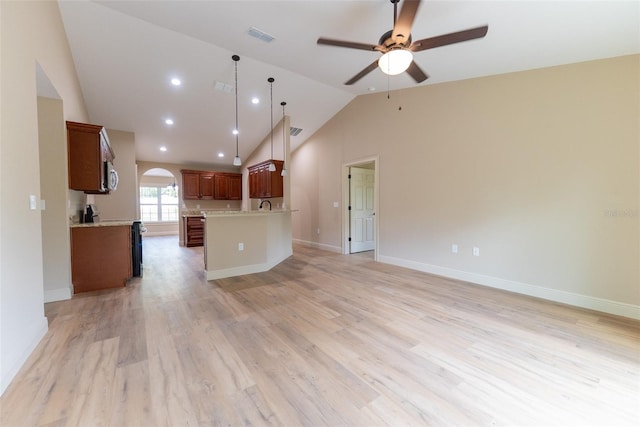 45 Pecan Course Loop, Ocala, FL 34472 - unfurnished living room featuring vaulted ceiling, a ceiling fan, arched walkways, light wood-style floors, and recessed lighting