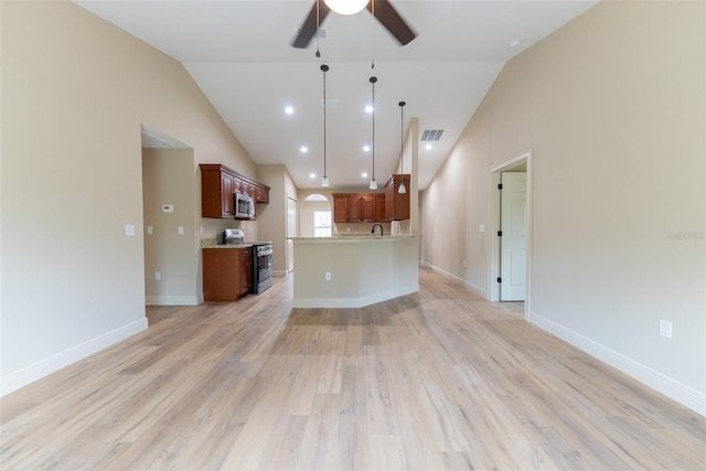 45 Pecan Course Loop, Ocala, FL 34472 - unfurnished living room with a ceiling fan, lofted ceiling, light wood finished floors, and arched walkways