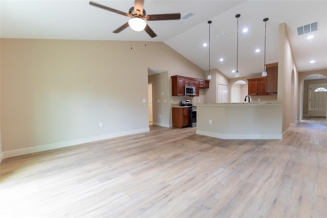 45 Pecan Course Loop, Ocala, FL 34472 - unfurnished living room featuring arched walkways, a ceiling fan, light wood-style flooring, high vaulted ceiling, and recessed lighting