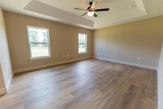 45 Pecan Course Loop, Ocala, FL 34472 - empty room featuring a tray ceiling, light wood-type flooring, a ceiling fan, and a smoke detector